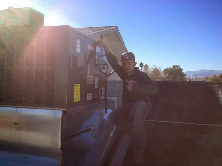 HVAC technician performing HVAC Inspection on a rooftop unit in Fremont
